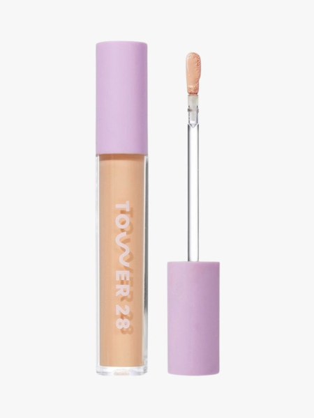 Tower 28 Swipe Serum Concealer beige bottle with purple top and purple and clear applicator on light grey background